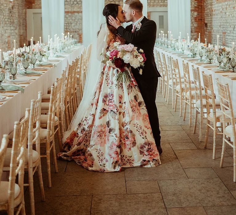 Pink wedding colour scheme with pink tablescapes, pink wedding bouquet and pink flower wedding dress with the groom wearing a pink tie 