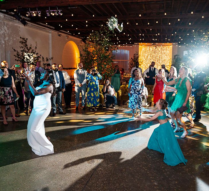 Bride dances during wedding reception surrounded by wedding guests at Trinity Buoy Wharf 