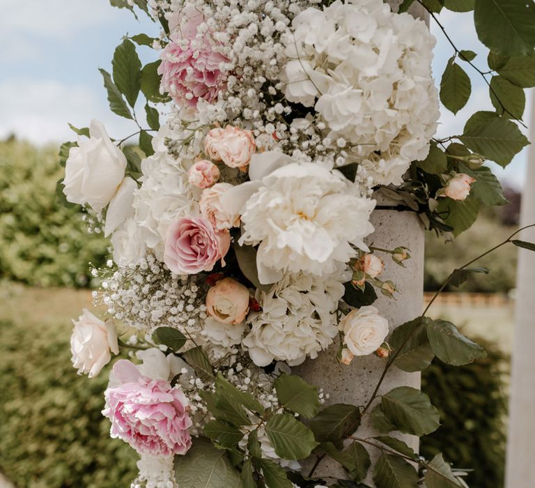 Pastel pink and white florals complete with green foliage 