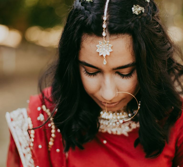 Bride wears embellished hair accessories with floral design 