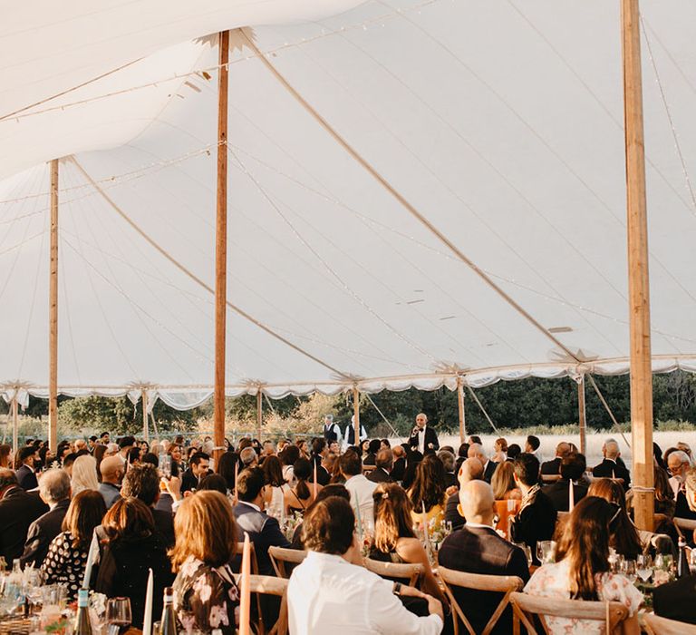 Outdoor black-tie wedding reception in sailcloth tent 