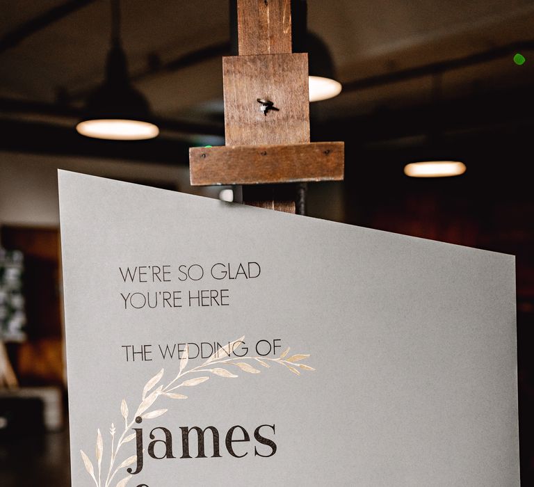 Modern wedding signage on wooden easel 