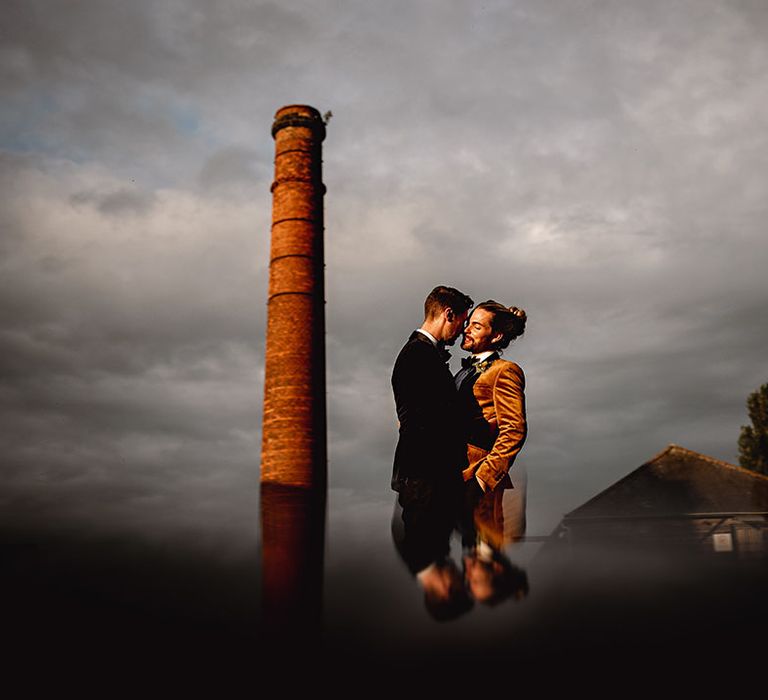 Groom wears velvet smoking jacket complete with floral buttonhole 