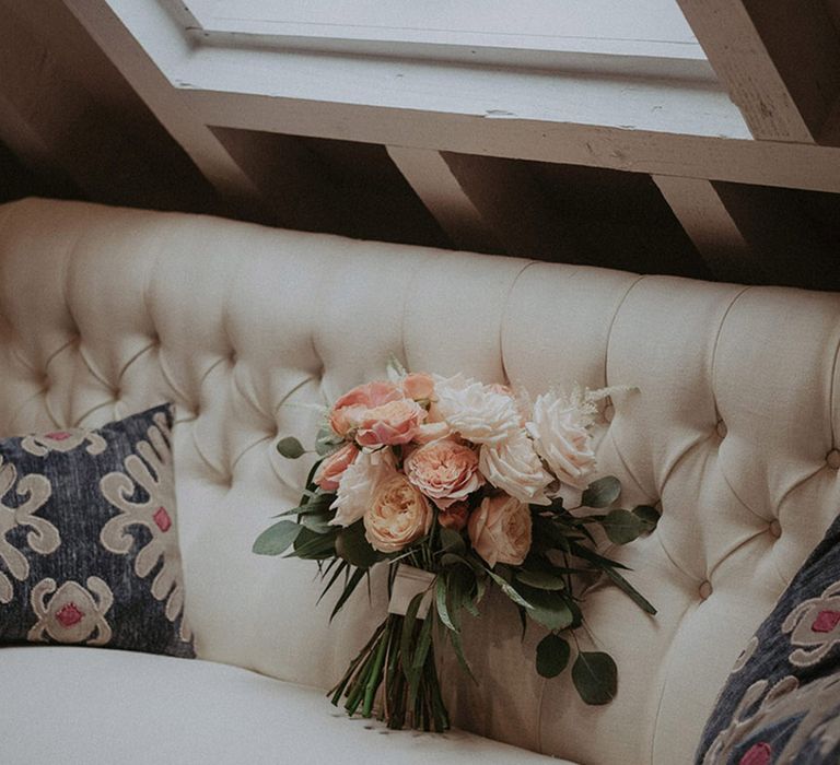 White and baby pink roses and peonies bridal bouquet with greenery for rustic luxe wedding at Stanlake Park 