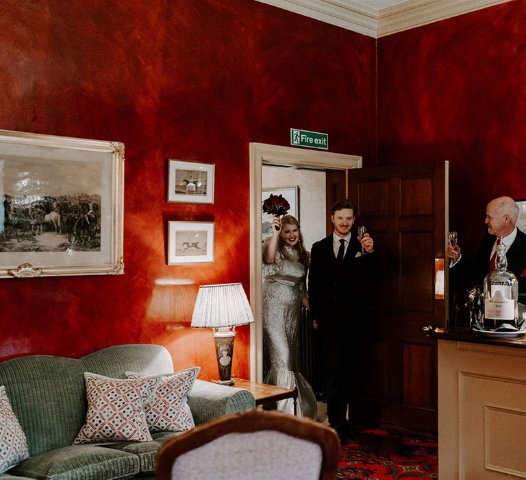 The bride and groom enter their wedding reception at Hambleton Hall in the East Midlands 