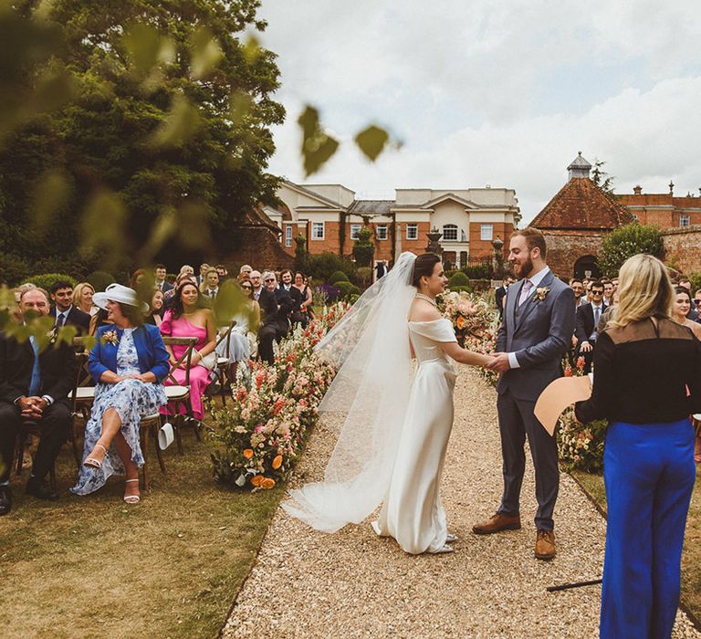 Bride and groom at their outdoor wedding with handfasting ceremony 