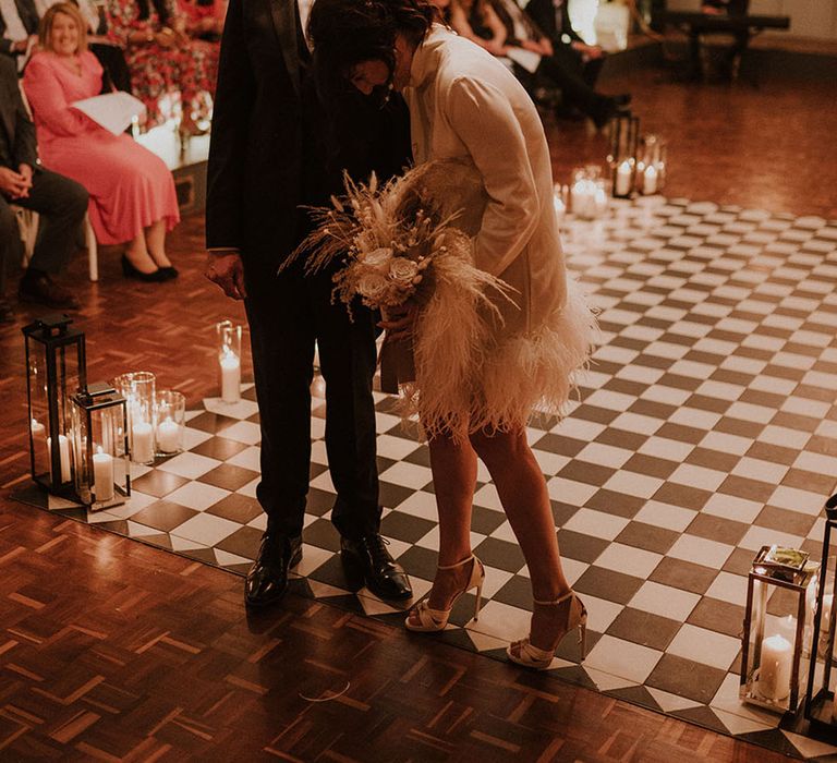 Bride ad groom stand together at their cosy romantic wedding ceremony at Larkspur Lodge