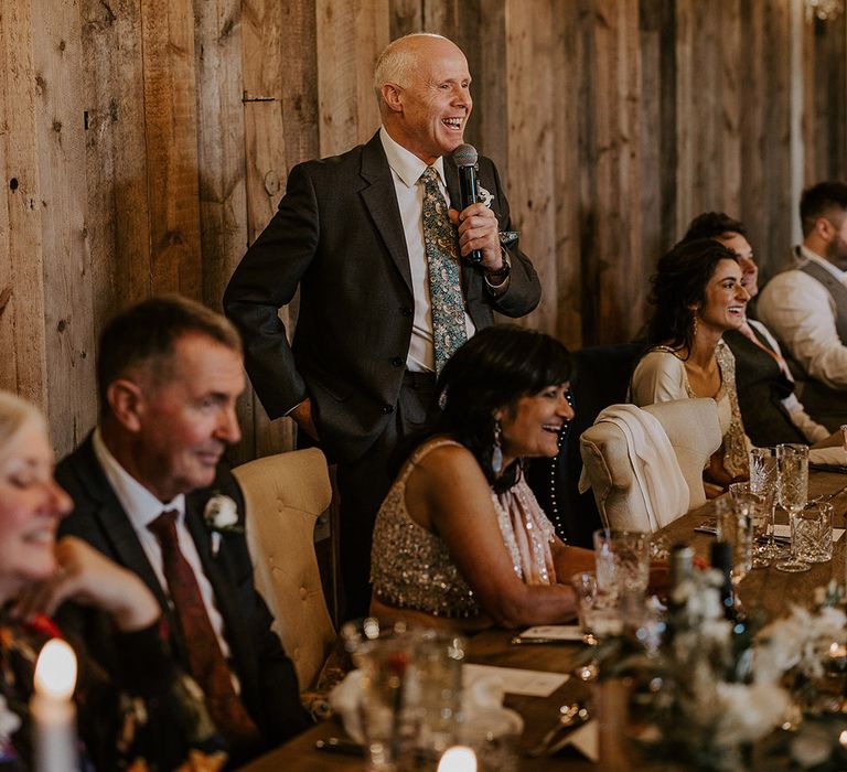 Father of the bride reads out his wedding speech to the guests 