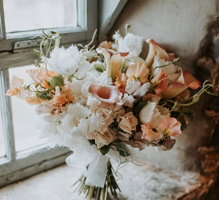 Pink and white blush neutral wedding bouquet for the bride with sweet peas 