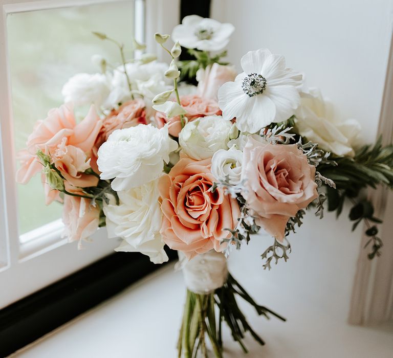 Pink and white wedding bouquet with roses and anemones 