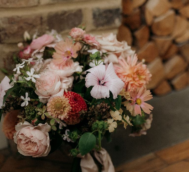 Pink and peach wedding bouquet with cosmos, peonies and waxflower 