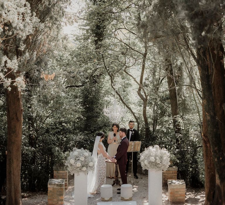 Outdoor wedding ceremony at Italian villa with white flower decorations 