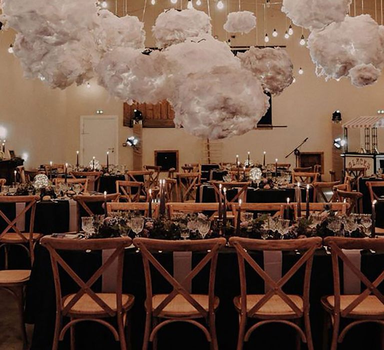 Cloud shaped lights hanging above table by Lyse Kong Photography