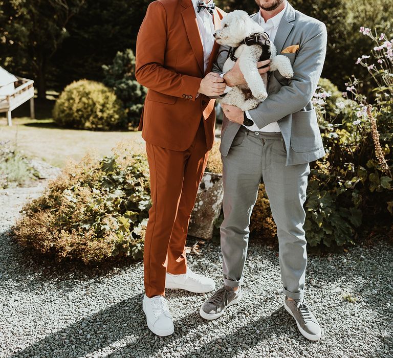 Two grooms posing with their pet dog, Walter 