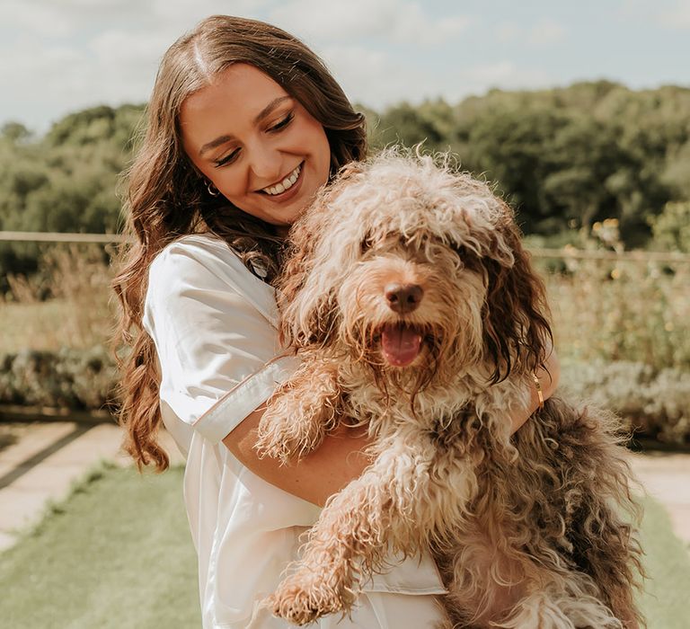 Bride in white satin PJs with pet dog 