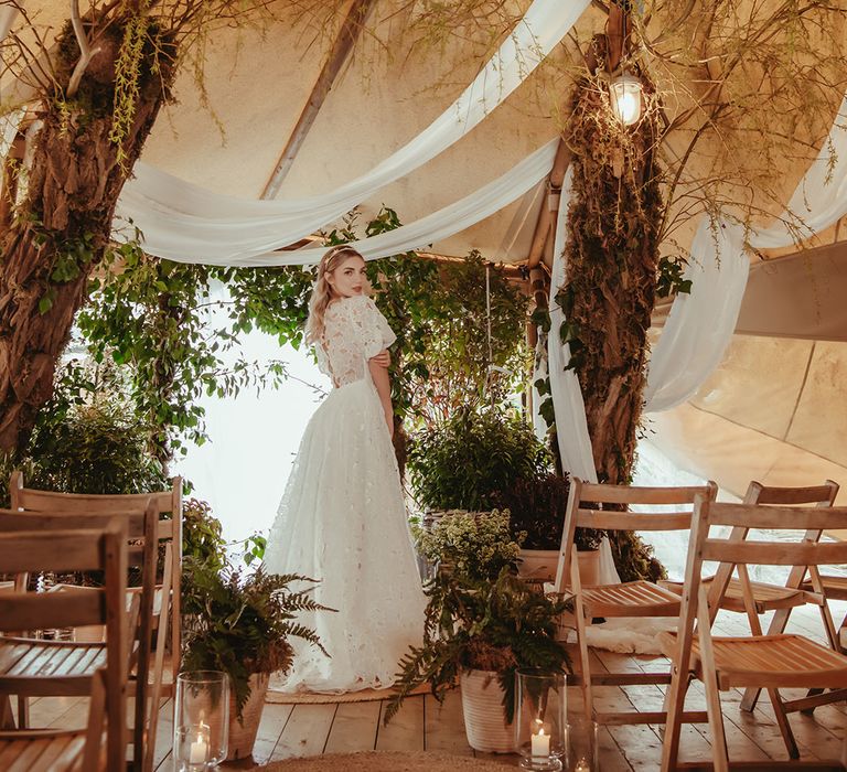 White drapery decorations with botanical foliage at sustainable wedding editorial shoot 