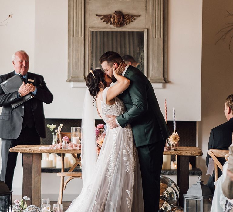 The bride and groom share their first kiss as a married couple 