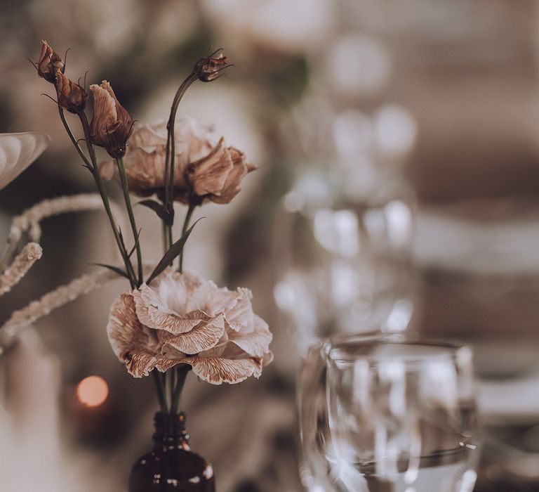 Minimalist wedding table decor with bud flower arrangements 