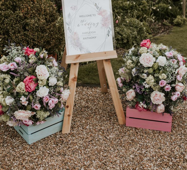 Wedding welcome sign and floral arrangements at Barn wedding 