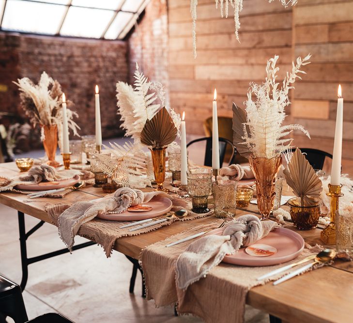 Romantic table decor with taper candles, dried flowers and natural linens 