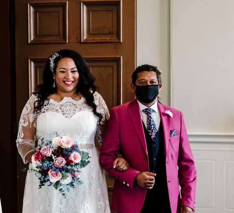 Bride to be with her father walking her down the aisle with fuchsia pink suit jacket 