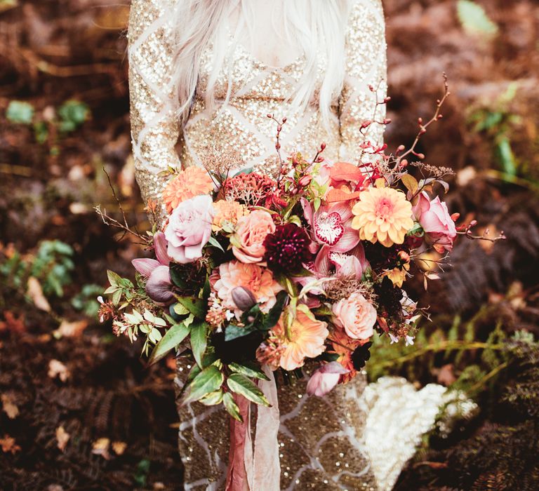 Bride with oversized pink and blush flower crown and gold sequin dress. Photography by Maryanne Weddings.