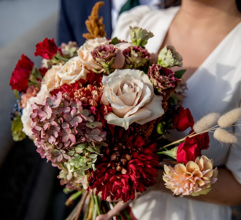 Red and cream wedding bouquet with hydrangea head, roses and dahlias 