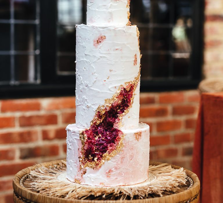 3-tier wedding cake featuring pink and gold decoration 