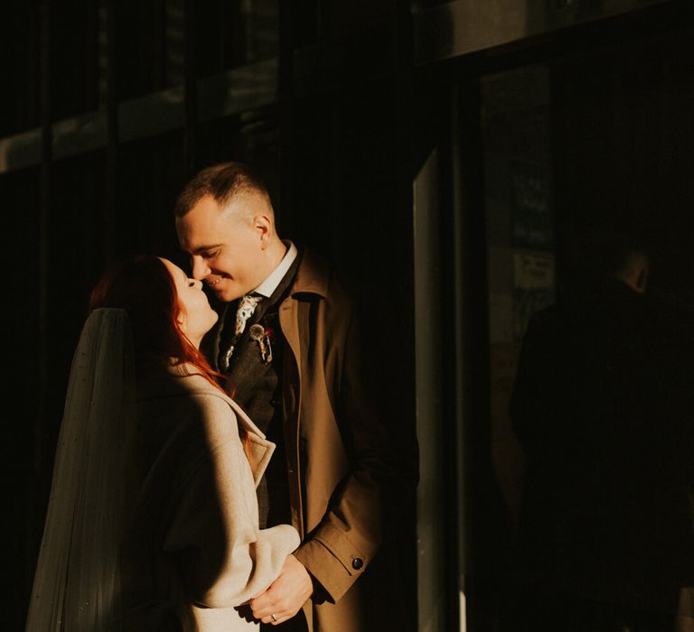 Romantic wedding photography of bride and groom holding each other for London city wedding 