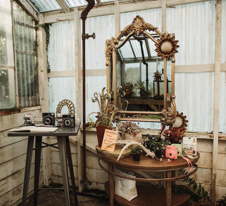 Polaroid station with ornate mirror and guest book 