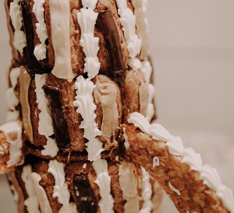 An epic and unique eight tier eclair wedding cake