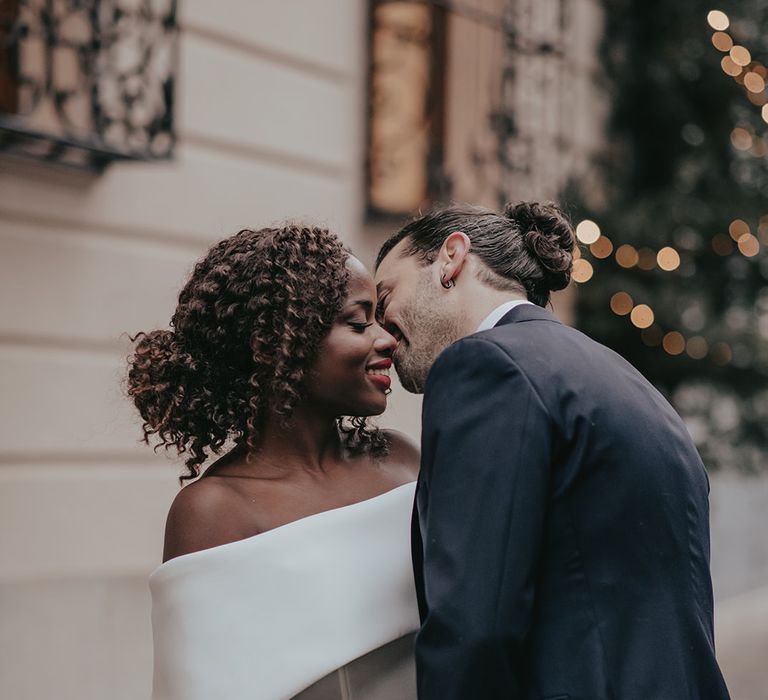 Bride & groom kiss outdoors on the streets