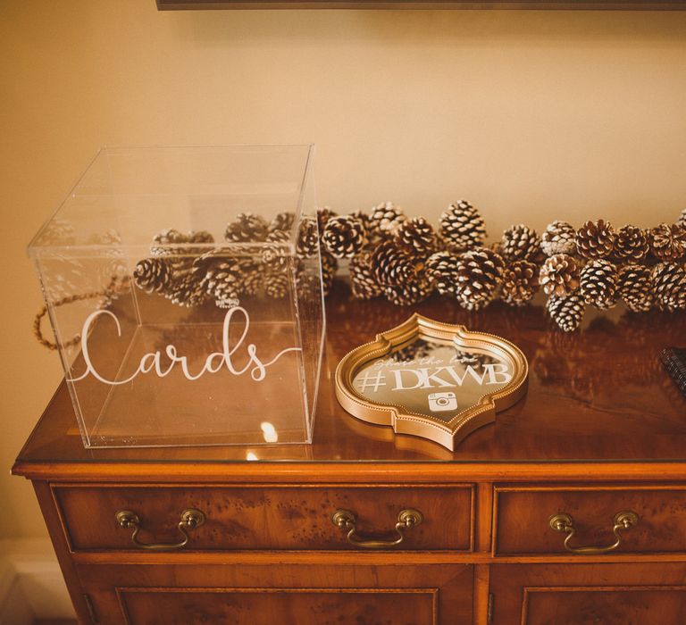 Wedding guest book and card table decorated with pinecones 