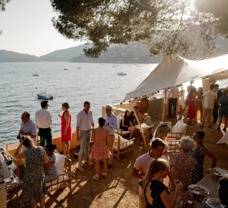 Guests enjoy a drink overlooking the sea at French villa