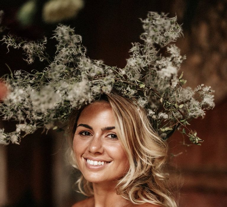 Bride with large abstract wildflower wedding headpiece