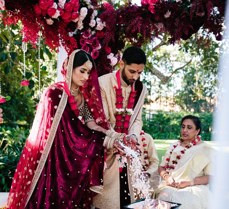 Bride & groom during wedding ceremony outdoors