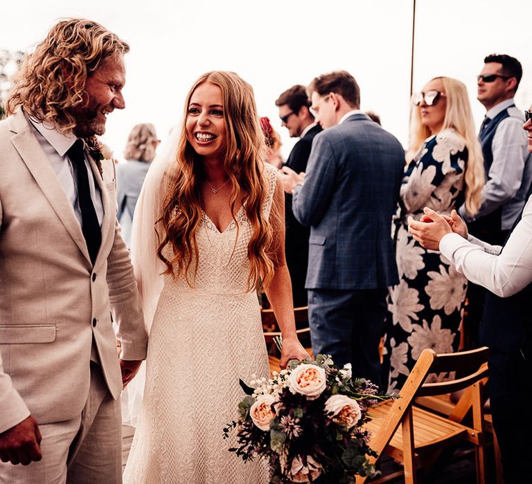 Bride and groom walk up the aisle after outdoor ceremony