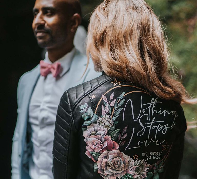 Bride wears her personalised leather jacket complete with floral illustrations 