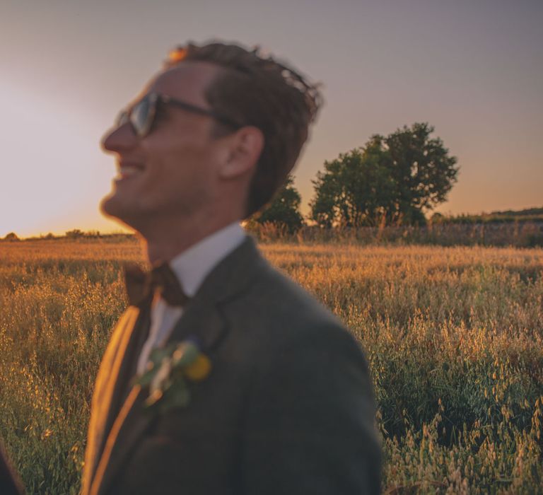 Grooms laugh and look lovingly at one another on their wedding day | Story + Colour