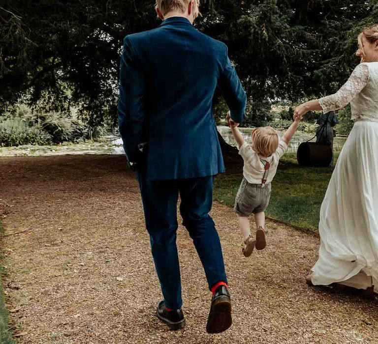 Bride and groom enjoy some time with their son as they stroll through the grounds of Cadhay House