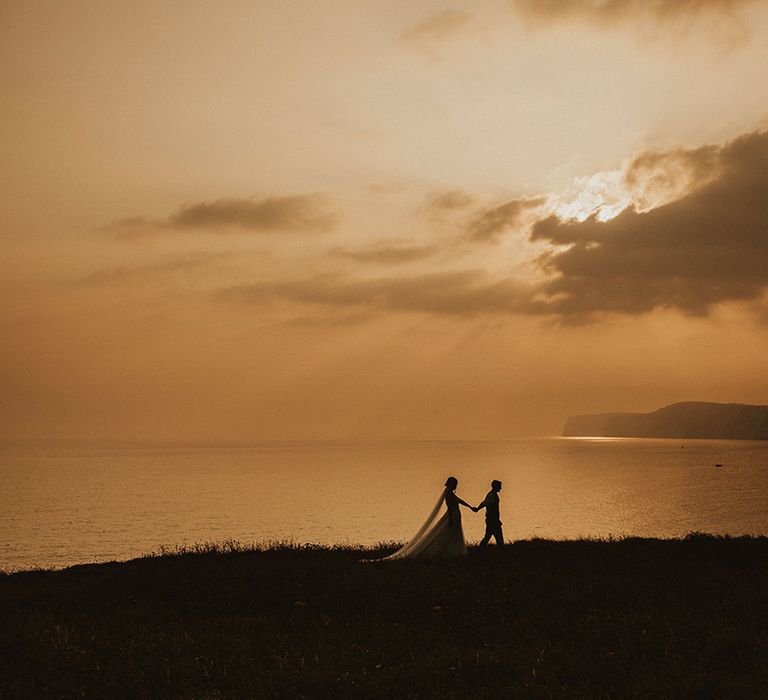 Beautiful sunset shot of bride and groom at Isle of Wight coastal wedding