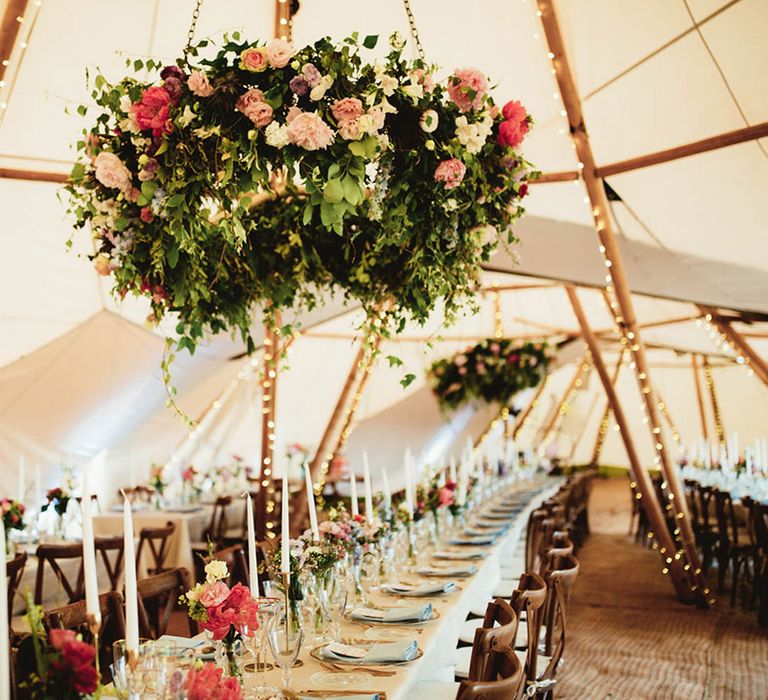 Rustic styled tipi complete with colourful trees and gold inspired inserts across tablescape 