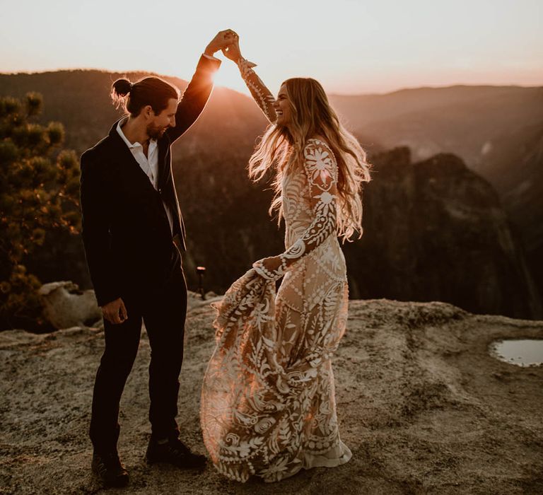 Bride & groom dance on mountain top