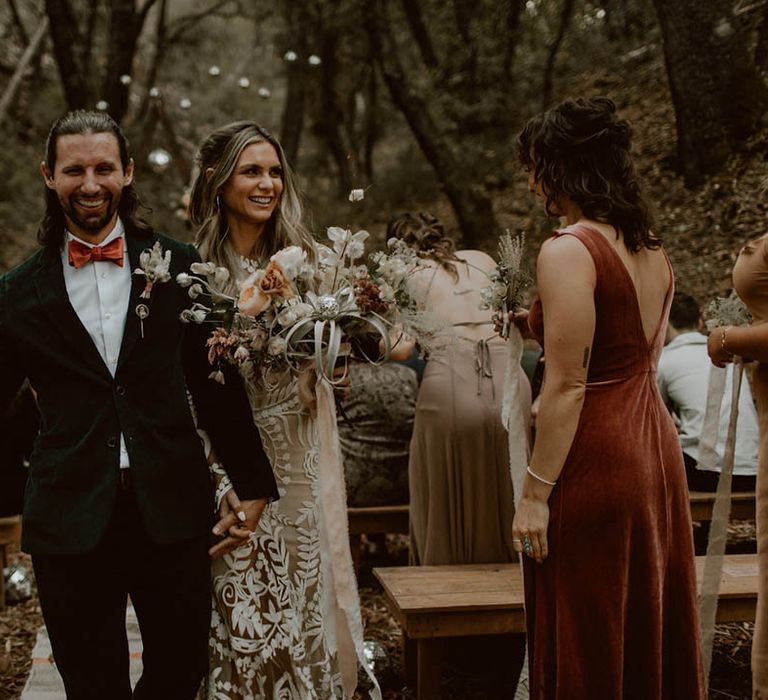 Bride & groom walk down the aisle with one another