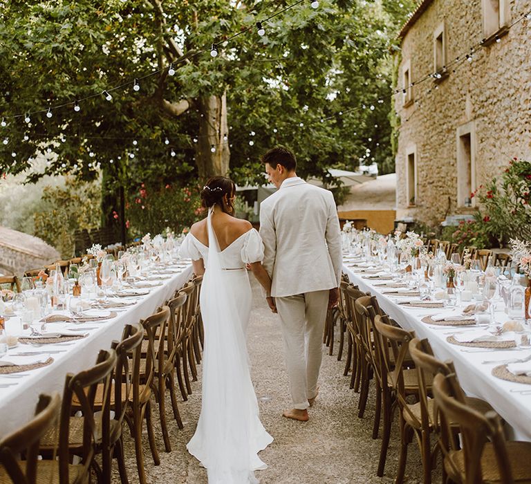 Bride and groom walk in the reception area 