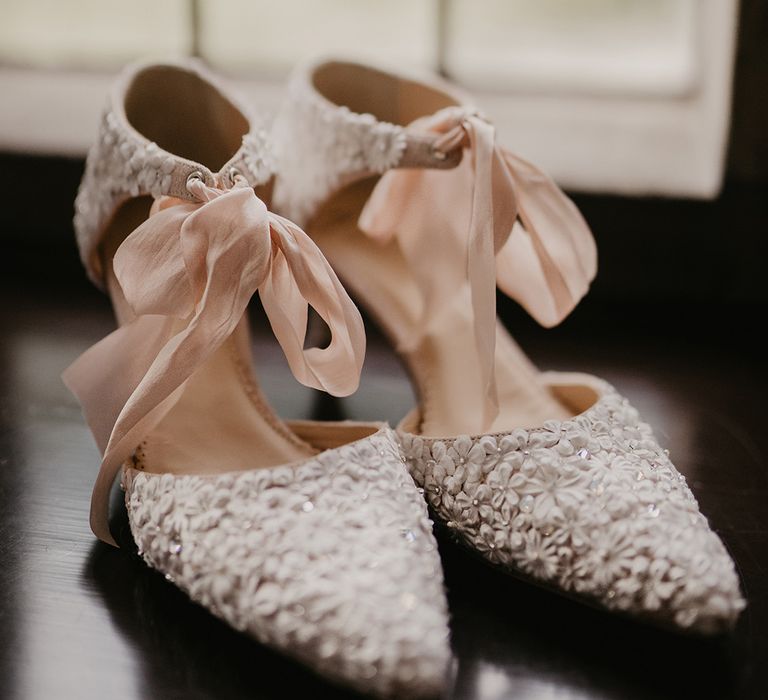 Wedding shoes with tiny flowers and pink ribbon 