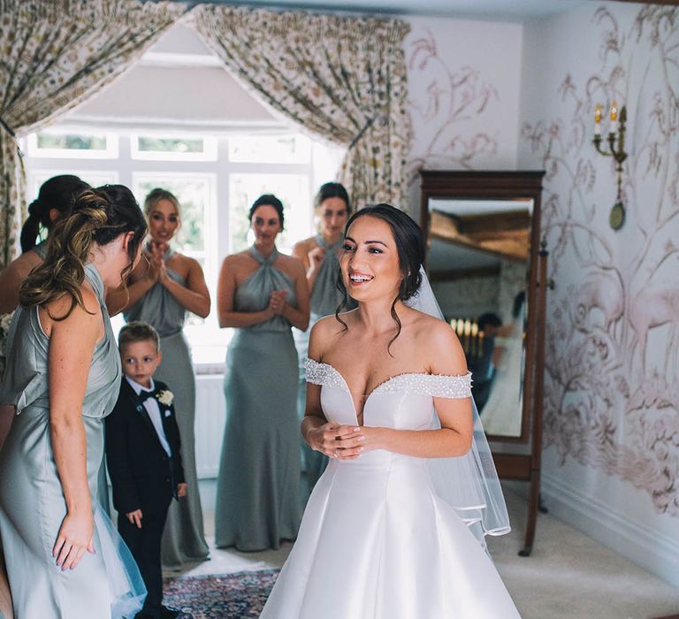 Bride in her gorgeous Pronovias wedding gown with her bridesmaids in mint green dresses on the morning of her wedding 