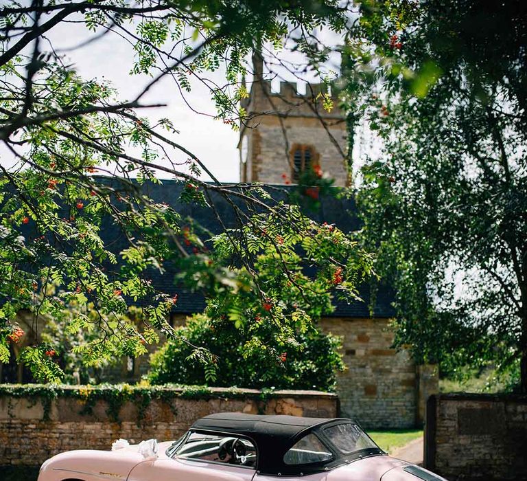 Peach pink classic wedding car with black hood