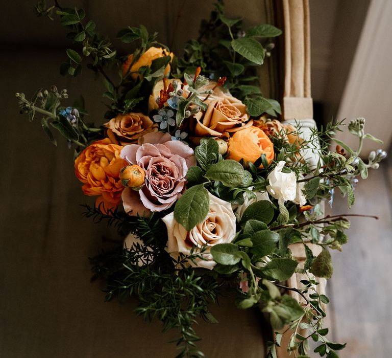 Bridal bouquet with blue, orange, yellow and pink flowers 