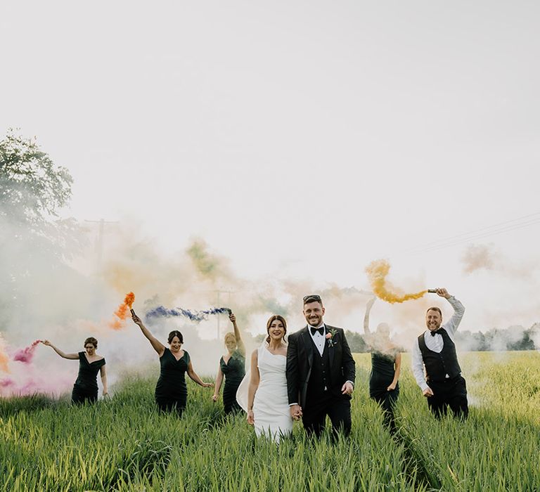 Bride and groom have smoke bomb photoshoot with their wedding party